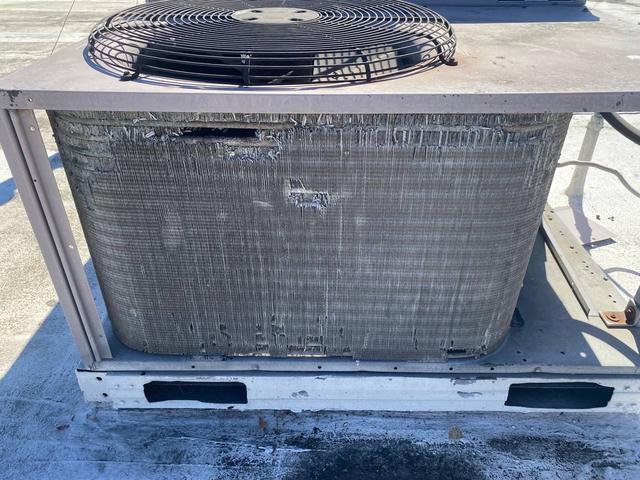 Broad view of condenser coil damage.
