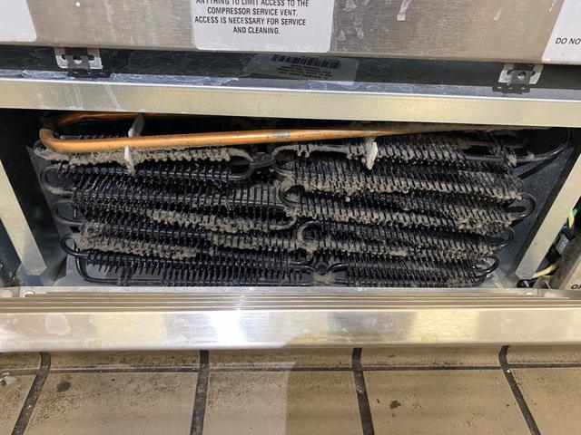 Condenser with visible dust accumulation.