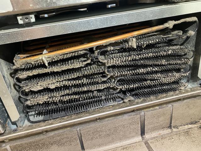 Dust accumulation at the condenser assembly.