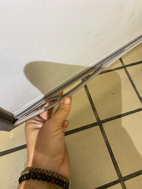Separated or damaged lower door gasket.