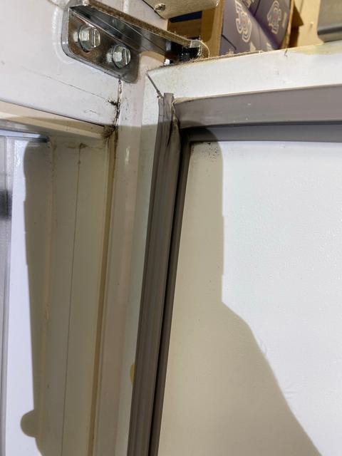 Damaged upper-corner gasket.