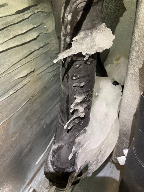 Close view of ice on insulated piping.