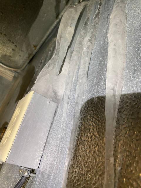 Icicles and ice streaks on an interior wall.