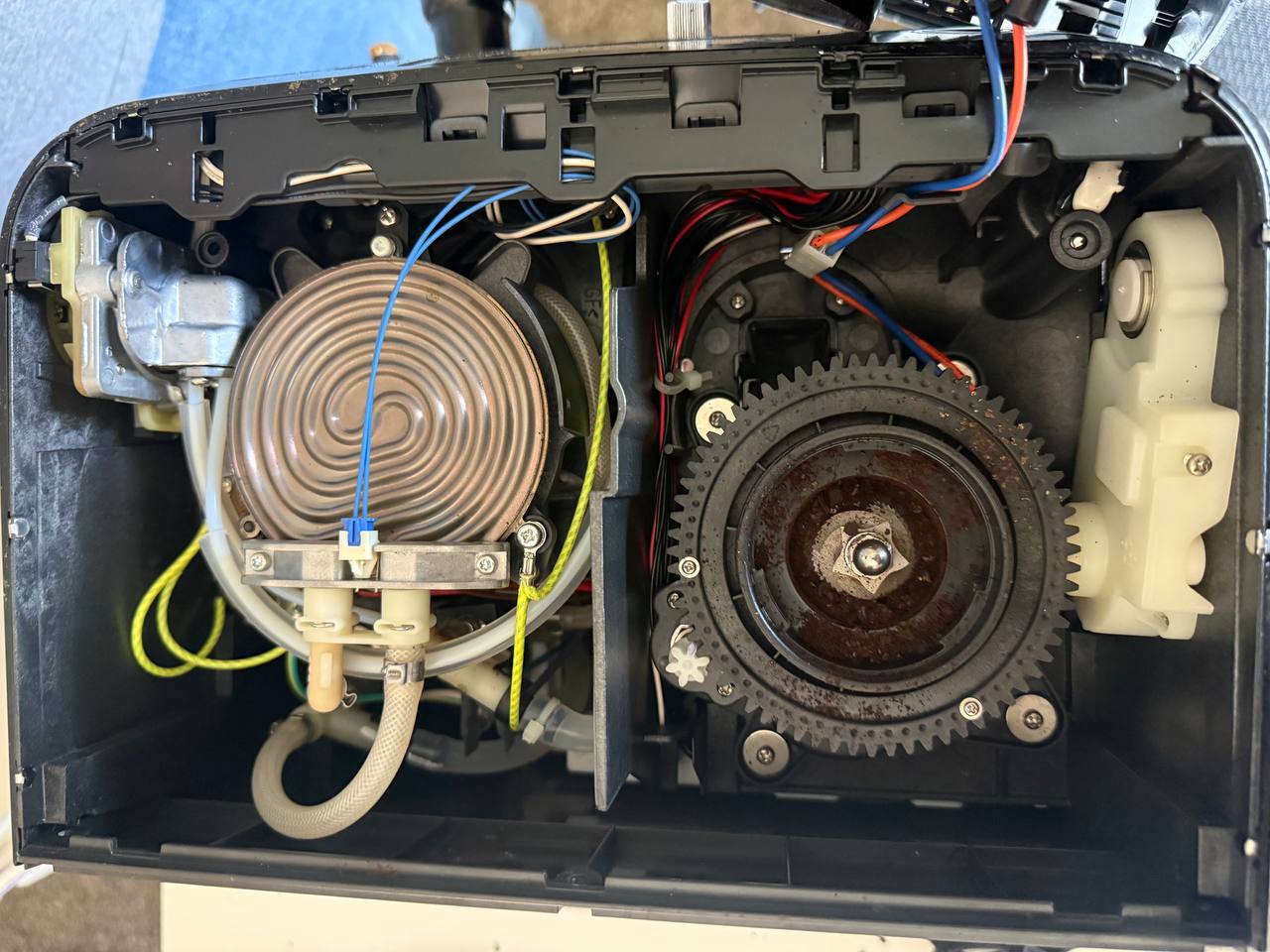 Inside the Breville: the heater element on the left and the grinder gear assembly on the right.