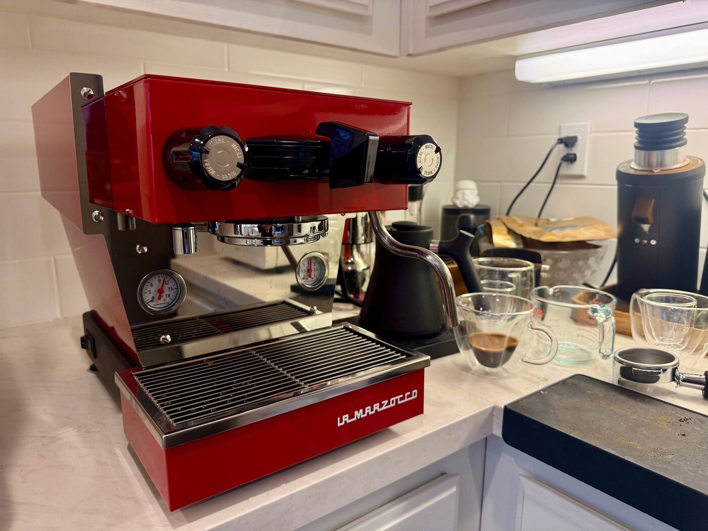 Red La Marzocco Linea Micra pulling a fresh espresso at a client's home in the Bay Area.