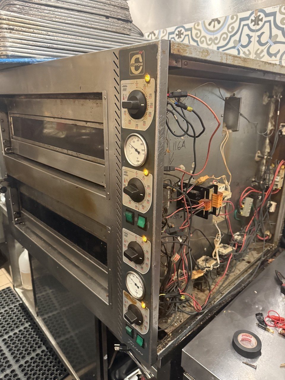 Cuppone deck oven control side open at Locanda Wine Bar, showing the thermostat bank and wiring