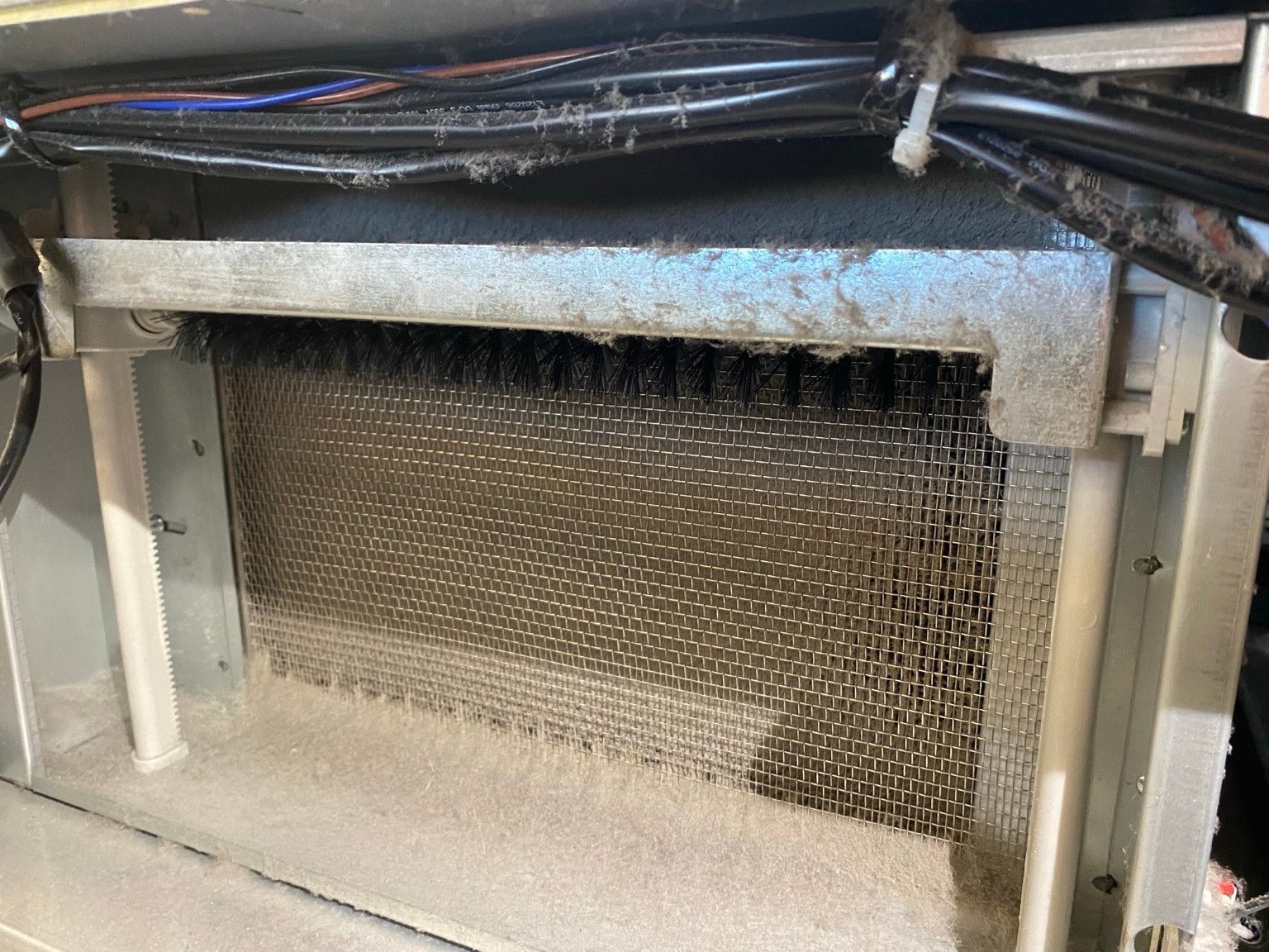 Dust and lint across a Turbo Air freezer condenser.