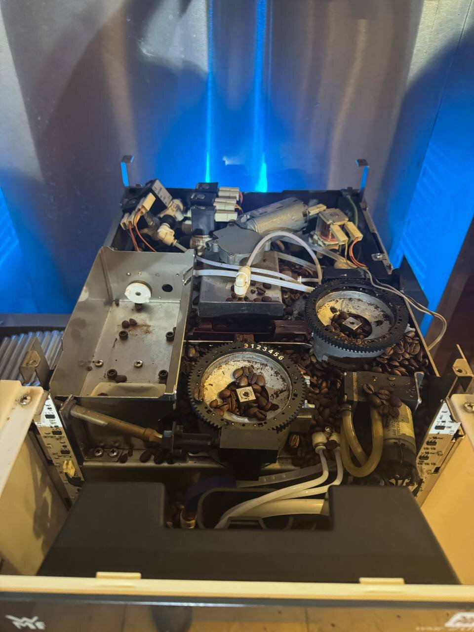 Inside the WMF with the top panel off, both grinders visible